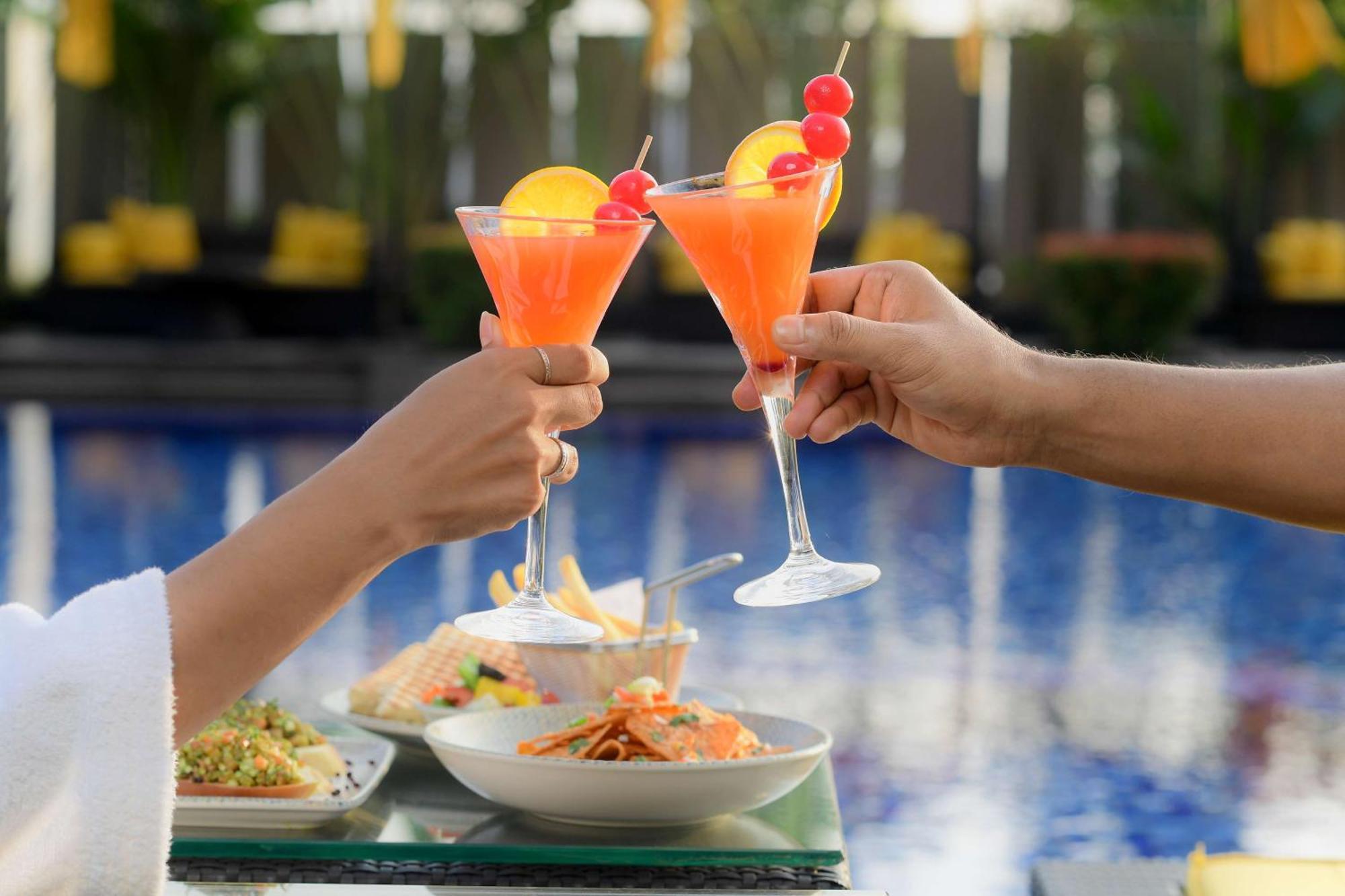 Radisson Blu Hotel Guwahati Eksteriør billede A couple toasting with cocktails